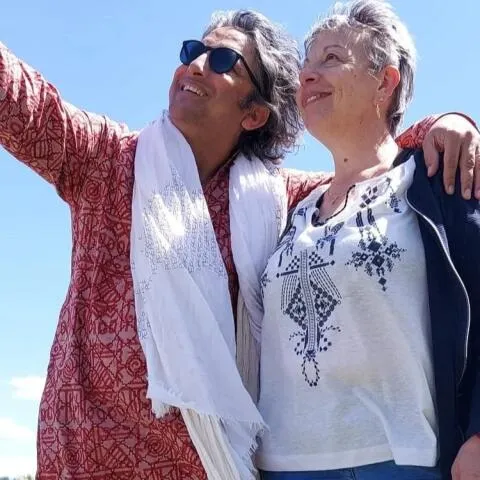 A man and a woman standing close together outdoors
