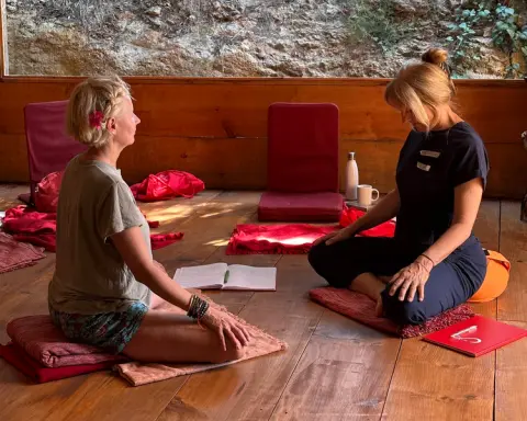Two people participating in a blindfolded trust or sensory exercise in a studio