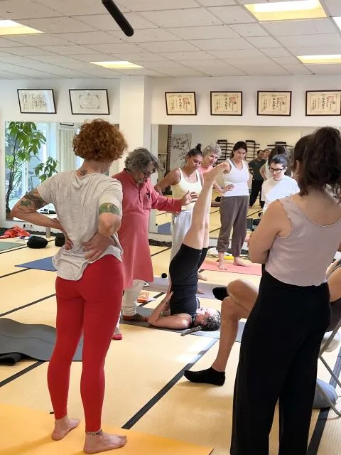 Sanjeev helping student in yoga