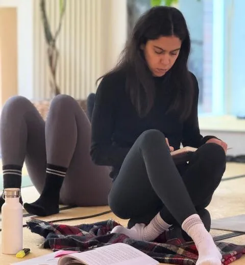 Student journaling during yoga workshop.